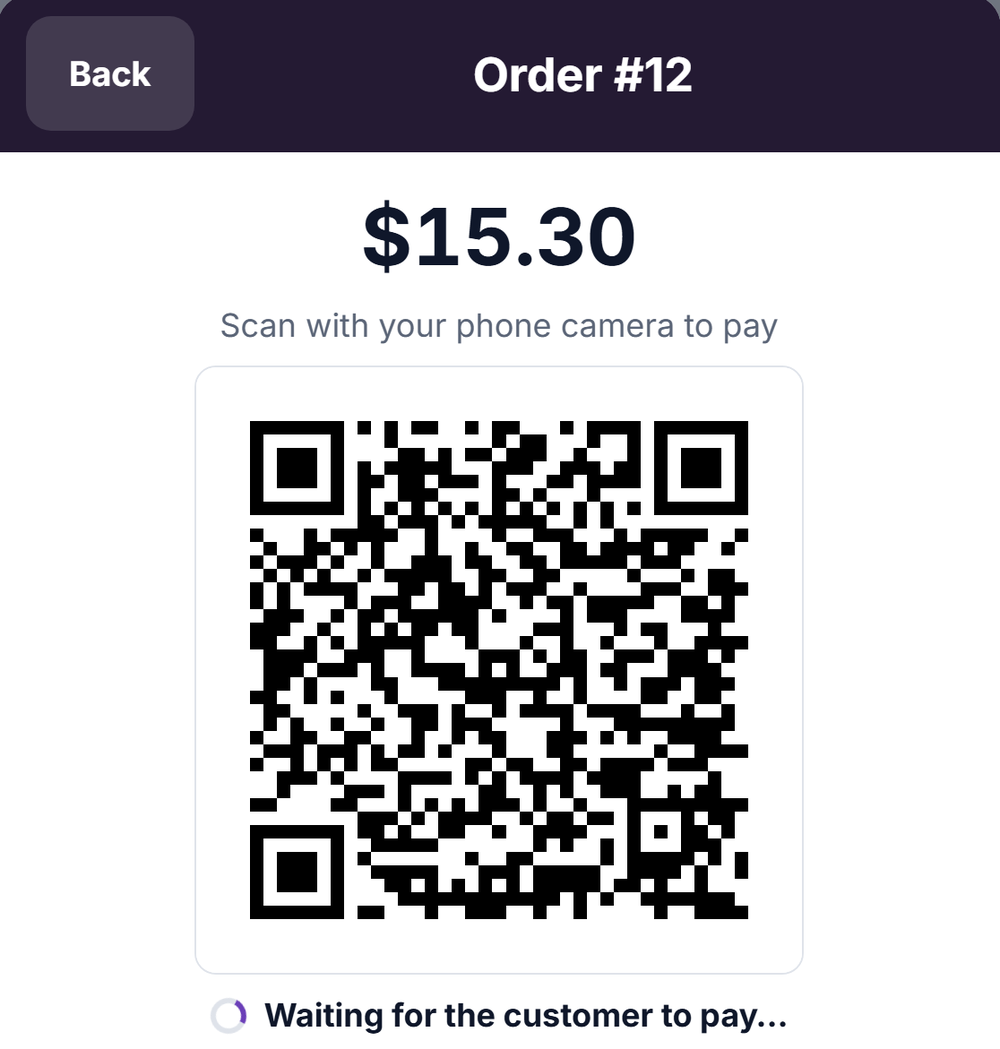 The Scan to Pay screen on the register: the amount due, a QR code, and a line saying the register is waiting for the customer to pay.